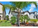 Charming two-story home showcases lush landscaping, a healthy mature palm tree, and well-maintained exterior at 8330 Vivaro Isle Way, Windermere, FL 34786