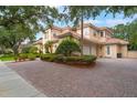 Spacious driveway leading to a well-maintained home with a terracotta roof and attached garage at 8814 Southern Breeze Dr, Orlando, FL 32836
