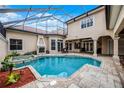 Enjoy the beautiful covered pool with a jacuzzi, a fireplace, and a tiled deck for outdoor relaxation at 8814 Southern Breeze Dr, Orlando, FL 32836