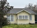 Cozy yellow house with a gray roof and white trim; great natural light at 972 Pinelli St, Orlando, FL 32803