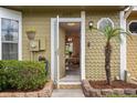 Welcoming front entry with a charming exterior, a small palm tree, and lovely landscaping at 11735 Whitewing Ct # 11735, Orlando, FL 32837