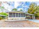 Inviting single-story home with a screened porch and carport, nestled in a serene, tree-lined neighborhood at 134 E Plantation Blvd, Lake Mary, FL 32746