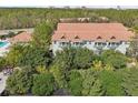 Aerial shot of a multi-Gathering home boasting a terra cotta roof and lush greenery at 14530 Damai Ln, Orlando, FL 32821