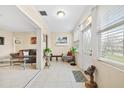 Bright, tiled foyer featuring a decorative bench and seamless transition to the living area at 1531 Norfolk Ave, Winter Park, FL 32789