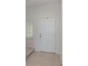 Bright entryway featuring a clean white door and neutral tile flooring at 2029 Crystal Bell St, Orlando, FL 32824