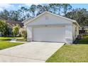 A single-Gathering home with a 2-car garage on a well-maintained lawn under a clear blue sky at 2978 Stillwater Dr, Kissimmee, FL 34743