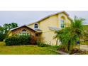 Charming two-story home featuring brick accents and a well-maintained front yard with lush greenery at 2989 Viscount Cir, Kissimmee, FL 34747