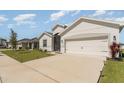 Charming home featuring a two-car garage, manicured lawn, and well-maintained landscaping at 4115 Ruby Run, Haines City, FL 33844