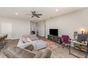 Open-concept living room with lots of natural light, modern furnishings, and a ceiling fan at 4115 Ruby Run, Haines City, FL 33844