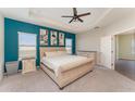 Spacious primary bedroom featuring a tray ceiling, a large window, and neutral decor at 4115 Ruby Run, Haines City, FL 33844