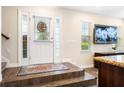 Warm entryway featuring wood-look tile floors and decorative glass on front door at 465 Gee Hammock Ln, Winter Springs, FL 32708