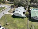 Bird's eye view of the home's backyard, neighborhood streets, and nearby homes with a pool and carport at 820 Dove Ridge Dr, Lakeland, FL 33803