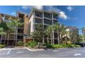 Multi-story condo building with balconies and well-maintained landscaping at 9051 Treasure Trove Ln # 505, Kissimmee, FL 34747