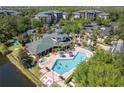 Aerial view of community clubhouse and a large outdoor pool at 9051 Treasure Trove Ln # 505, Kissimmee, FL 34747