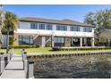 Waterfront home featuring large windows, a patio, and direct access to the water at 9138 Bay Point Dr, Orlando, FL 32819