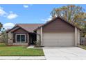 Well-kept single-Gathering home with an attached two-car garage and mature landscaping at 1080 Abell Cir, Oviedo, FL 32765