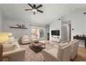 Bright living room with vaulted ceilings, neutral colors, and sliding glass doors to the patio at 1080 Abell Cir, Oviedo, FL 32765