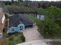 Aerial view of a waterfront home boasting a serene view of a lake and lush greenery at 10800 Cherry Oak Cir, Orlando, FL 32817