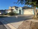 Beautiful house with a paver driveway, 2-car garage, and tropical landscaping at 10800 Cherry Oak Cir, Orlando, FL 32817