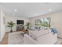 Spacious living room with recessed lighting, neutral decor, and large window offering ample natural light at 12621 Oulton Cir, Orlando, FL 32832