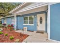 Inviting front porch with a white front door and manicured landscaping, creating a warm welcome at 1416 E 20Th St, Sanford, FL 32771