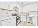 Well-lit kitchen with stainless steel appliances, white cabinets and countertops, and modern backsplash at 1416 E 20Th St, Sanford, FL 32771