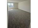 Spacious bedroom with soft carpeting, large window, and neutral color palette at 14734 Erice Ave, Clermont, FL 34714