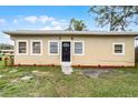 Charming single-story home with a well-maintained lawn and a classic black front door at 1622 Dolphin Dr, St Cloud, FL 34771