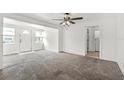Inviting living room showcasing new carpeting, bright paint, and a front entrance with natural light at 1622 Dolphin Dr, St Cloud, FL 34771