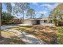 Inviting one-story home with a two-car garage, a beautiful lawn and mature landscaping at 184 Dublin Dr, Lake Mary, FL 32746