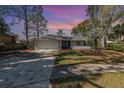 Charming single-story home featuring a two-car garage, mature trees, and a well-maintained front yard at 184 Dublin Dr, Lake Mary, FL 32746