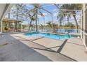 The screened-in pool area overlooks a serene lake, blending indoor and outdoor enjoyment at 184 Dublin Dr, Lake Mary, FL 32746