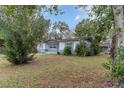 Quaint single-story home showcasing a well-maintained lawn and mature landscaping at 200 Avenue C, Chuluota, FL 32766