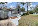 Close-up of home featuring a gray painted brick exterior and sidewalk at 200 Avenue C, Chuluota, FL 32766