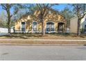 Traditional home with a manicured lawn, mature trees and beige exterior paint at 2073 Home Again Rd, Apopka, FL 32712