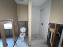 Bathroom featuring a walk-in shower, and a toilet at 2955 Banyan Ln, Lakeland, FL 33805