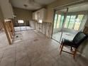 Kitchen featuring tile flooring, cabinets, and a sun room at 2955 Banyan Ln, Lakeland, FL 33805