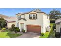 Well-maintained home featuring a two-car garage, neutral stucco facade and a neatly landscaped front yard at 5311 Brydon Woods Cir, St Cloud, FL 34771