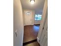 Light and bright foyer with wood-look flooring, a white front door, and an adjacent living space at 621 Daron Ct, Winter Springs, FL 32708