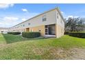 The grassy backyard features a screened porch and privacy bushes at 701 Fortanini Cir, Ocoee, FL 34761