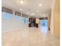 Spacious living room with tile flooring, recessed lighting, and large windows providing ample natural light at 8941 Rhodes St, Kissimmee, FL 34747