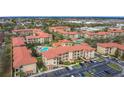 A beautiful aerial view of the condo community with pools, lush landscaping and ample parking at 912 Charo Pkwy # 214, Davenport, FL 33897