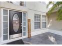 Close-up of the home's front door, complete with glass detailing and a welcome sign next to the entryway at 965 Rosinia Ct, Orlando, FL 32828