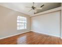 Inviting bedroom with hardwood floors, a ceiling fan, and ample natural light at 1019 Royal Oaks Dr, Apopka, FL 32703