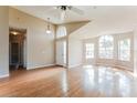 Bright living room boasting an open layout, hardwood floors, and large windows at 1019 Royal Oaks Dr, Apopka, FL 32703