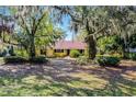 Inviting single-story home framed by mature trees and landscaping, offering a serene setting at 12002 Mckinnon Rd, Windermere, FL 34786