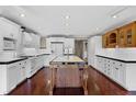 Spacious kitchen with white cabinets, black countertops, and a wooden island at 12002 Mckinnon Rd, Windermere, FL 34786
