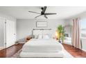 Serene main bedroom with a ceiling fan, hardwood floors, neutral tones, and natural light at 12853 Maryland Woods Ct, Orlando, FL 32824