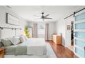 Inviting main bedroom featuring a ceiling fan, hardwood floors, neutral decor, and a closet at 12853 Maryland Woods Ct, Orlando, FL 32824