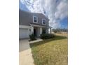 Beautiful exterior showcasing the manicured lawn and quaint covered entry at 137 Willow Dr, Kissimmee, FL 34759